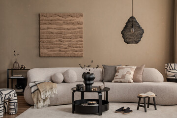 Stylish interior of living room with design sofa, art paintings and home decorations. Modern...