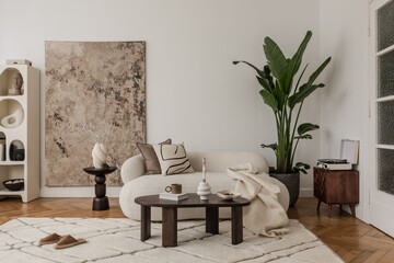 Cozy living room with abstract artwork, soft textiles and earthy accents, blending modern and...