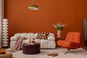 Stylish orange interior of living room with design sofa, decorations and home accessories.