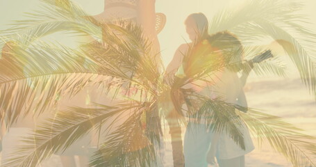 Naklejka premium Image of palm trees over diverse people at beach