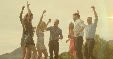 Image of smiling caucasian group of friends dancing with wine © vectorfusionart