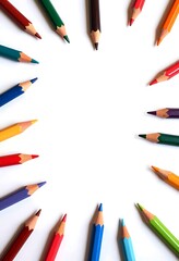 Fototapeta premium A vibrant arrangement of colorful pencils arranged in a circular pattern, creating a frame or border, with space in the middle