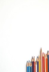 Fototapeta premium A set of colorful pencils arranged in a row, showcasing a variety of hues and tones. They're ready for drawing and adding color to a project.