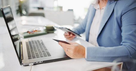 Phone, credit card and hands of business woman with internet, payment or ecommerce on laptop....