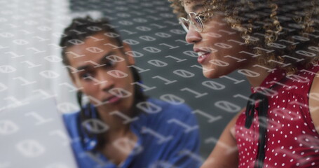 Image of binary coding over diverse business people using laptop