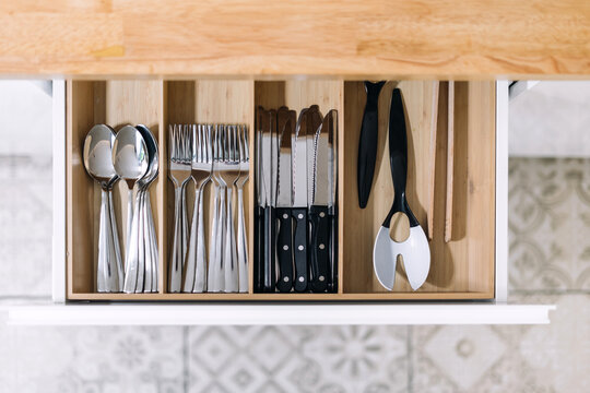 Well-organized kitchen drawer with utensils in modern home setting