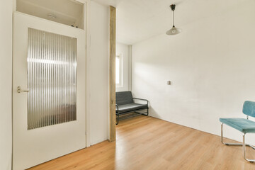 A bright and minimalistic interior space featuring clean lines, natural light, and simple furnishings. The design promotes a sense of openness and tranquility.