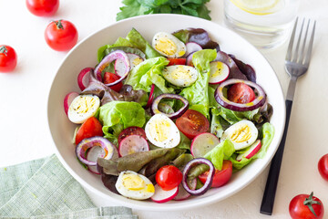 Salad with eggs, tomatoes, onions and radishes. Healthy eating. Vegetarian food.