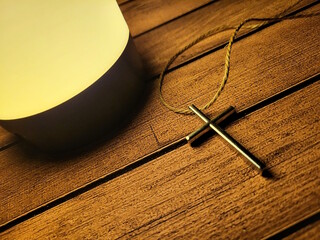 Metal Christian Cross Pendant on Wooden Table – Faith and Spiritual Symbol