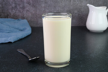 Serving vanilla milkshake in a glass cup.