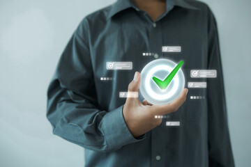 A man in a gray shirt holding a glowing checkmark icon surrounded by task icons—indicating...