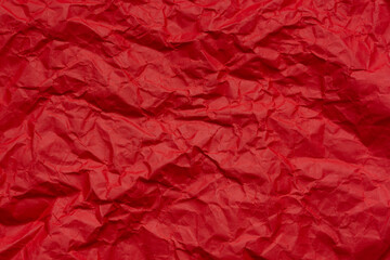 Red crumpled paper texture macro,Red crumpled paper as a texture or background. Bright red crumpled paper for backgrounds, design, packaging, holiday cards or creative projects, for valentines,