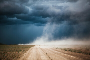 Dust Storm and grey storm clouds over a dirt road, Ulgii (Olgii), Western Mongolia, Mongolia