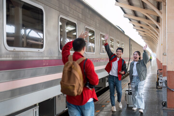 Farewell and Travel Adventure. Friends waving goodbye at a train station as they embark on a new journey.