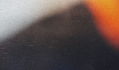 grainy colorful warm orange light leaks on black background with dust texture. abstract damaged...