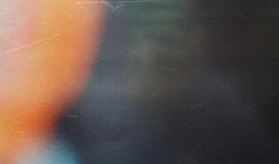 grainy colorful warm orange light leaks on black background with dust texture. abstract damaged...