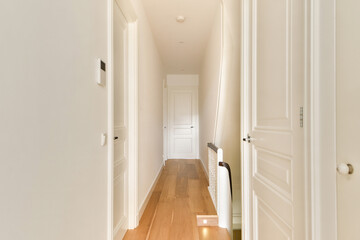 A sleek and minimalist indoor hallway featuring clean lines, wooden flooring, and bright light...
