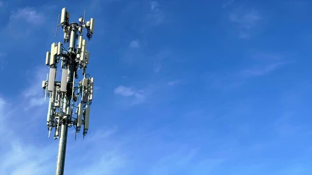 Low angle time lapse of cell site tower equipment, T-Mobile, Verizon, att cellular communication pole