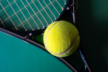 Tennis Racket and ball on brilliant green wallpaper, flat lay.Promotional background for tennis...