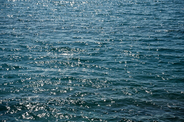 Deep blue sea. Waves on the sea at evening. Reflection of the sun on the surface of the water. Sea surface. 