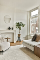 A stylish modern living room featuring a cozy sofa, decorative plants, and minimalist decor. The bright space emphasizes comfort and elegance.