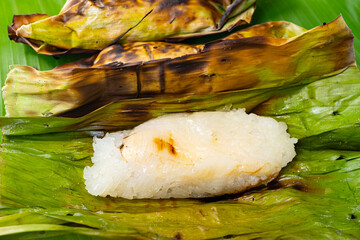 Thai street food, Grilled sticky rice with banana wrapped in banana leaves, The sweet taste of bananas and coconut milk blend together harmoniously, It smells so good.