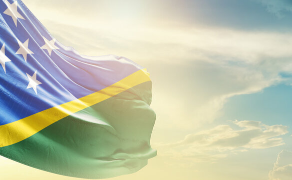 Solomon Islands flag wave in soft clouds. National flag beautifully waving in the sky. Solomon Islands national flag for independence day.