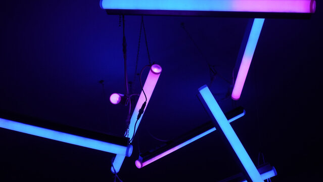 Futuristic Blue and Pink Neon LED Tubes Illuminating a Dark Abstract Space