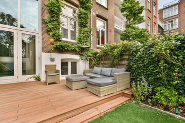 A stylish outdoor area featuring comfortable seating surrounded by lush greenery and modern design elements that enhance relaxation and aesthetic appeal.