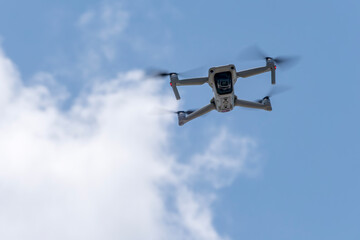 A Small Drone Flying in the Sky on a Bright Sunny Day