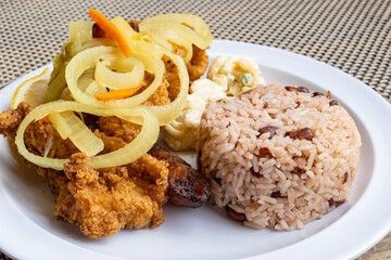Tender Fried Groupers Served with Pickled Onions and Rice and Beans