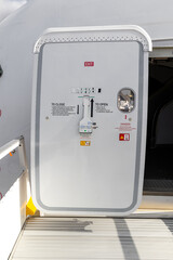 Open aircraft passenger door as seen from the stairs.