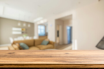 Fototapeta premium Wooden table with blurred luxury living room interior background for product display