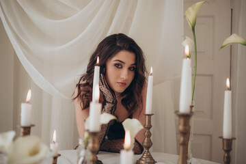 Elegant mood portrait of woman in candlelit setting
