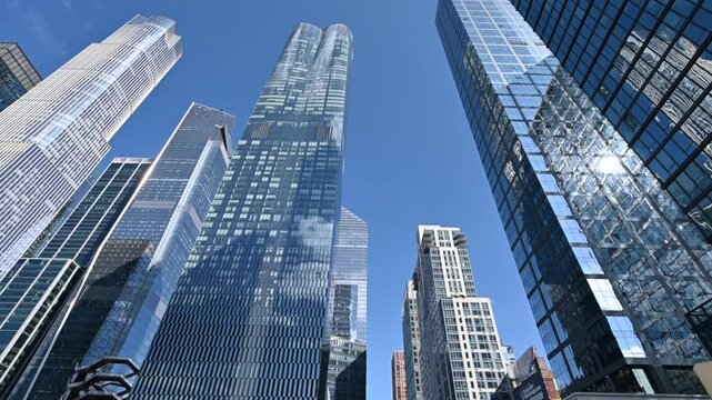 New York City, USA, August 20, 2024. Walking on the High Line following the old dead-end track. Looking up we admire the large, modern skyscrapers with mirrored facades. Cityscape, city life.