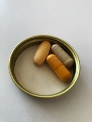 close up shot of daily vitamins supplements on white background