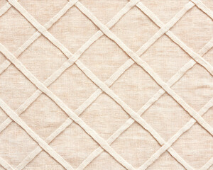 Beige fabric with crisscross stitched pattern