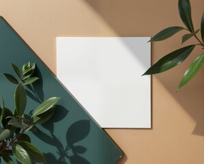 A minimalist composition featuring a blank white page surrounded by green leaves and a dark green surface, highlighting simplicity and nature.