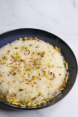 Closeup of Sutarfeni, a traditional Indian sweet made from fine sev soaked in sweet saffron flavored milk, garnished with dry fruits. perfect for festive celebrations and Indian cuisine themes. copy