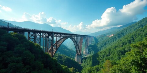Obraz premium Majestic Steel Arch Bridge Spanning Verdant Mountain Valley Under a Summer Sky
