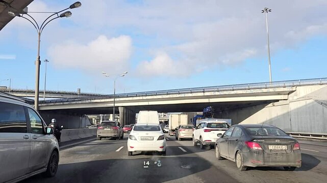 Moscow April 04 2025, A busy highway with a lot of cars and a truck. The cars are stopped at a red light
