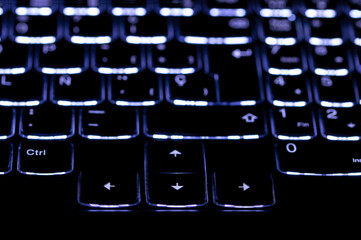 Modern computer keyboard for gamers with blue neon light. Colorful concept.