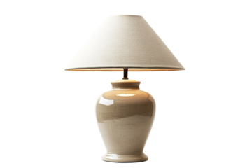 Lit table lamp a beige shade above a ceramic vase base, casting soft light