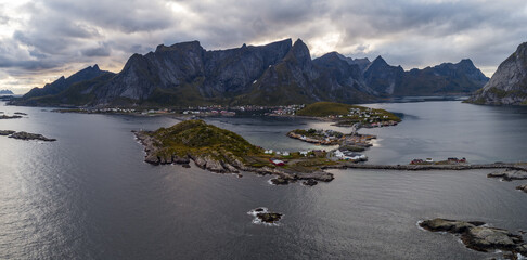 Aerial panoramic view of Lofoten coastline with fishing villages and dramatic mountains in autumn, Norway