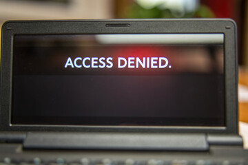 Access denied message displayed on laptop screen symbolizes termination of access to system or concept