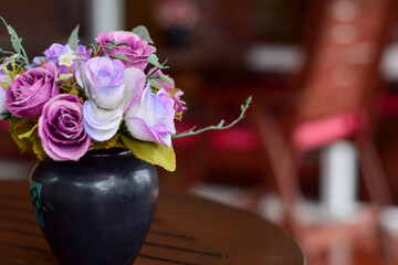 Flowers made of pink fabrics in a Vase on blown Table. in coffee shop, vintage color tone