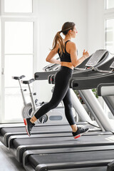 Woman Running on Treadmill in Modern Gym