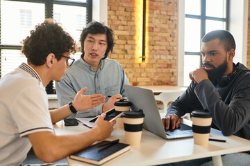 Collaborative brainstorming session in a modern office environment with focused professionals