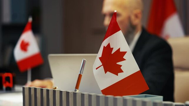 Canadian embassy officer stamping document seal, processing visa application