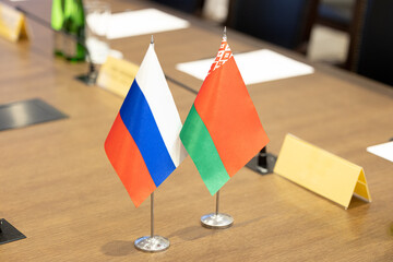 Flags of cooperation between Russia and Belarus. Flags of Russia and Belarus on the negotiating table. Ideal for news.